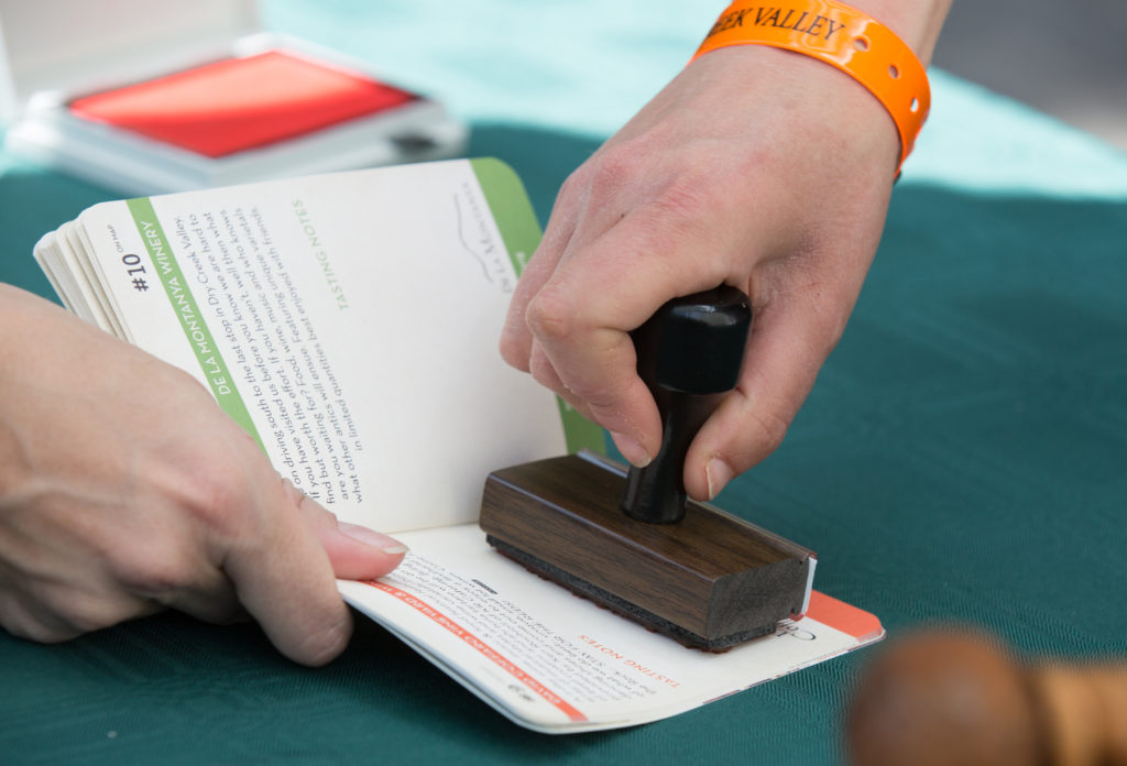 People have their passport stamped while stopping at Coffaro Vineyard and Winery during the annual Passport to Dry Creek Valley near Geyserville, Calif. Saturday, April 25, 2015. Over 60 wineries and 150 growers in the Dry Creek Valley opened their doors to to tasters participating in the event.