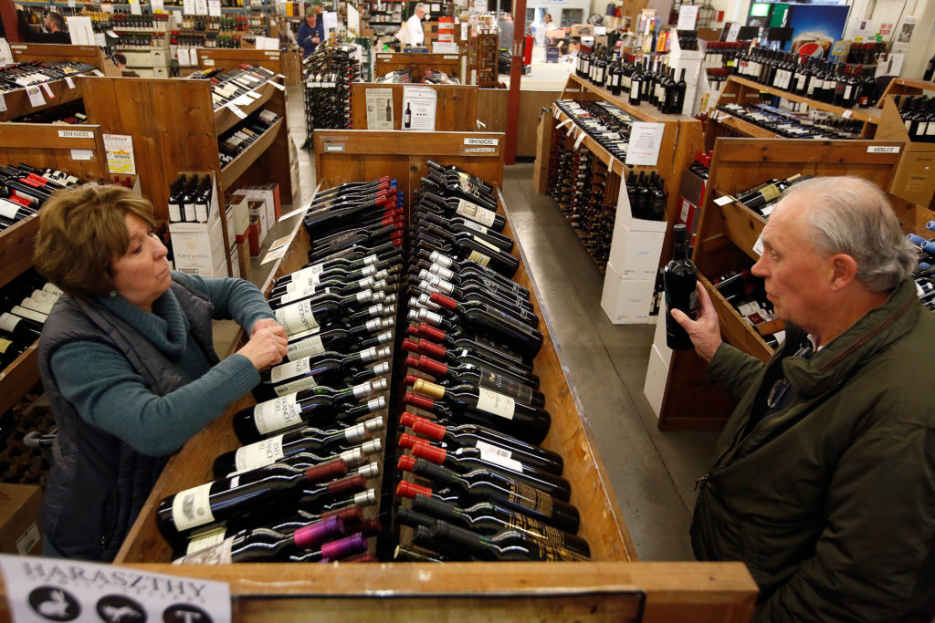 Marlene and Buzz McNaughton, visiting from Pittsburg, Pennsylvania, discuss their selection of local wine at Bottle Barn in Santa Rosa, California, on Wednesday, January 24, 2018. Wine shipments in volume increased 1.3 percent and overall wine sales increased almost three percent last year, according to the Unified Wine and Grape Symposium. (Alvin Jornada / The Press Democrat)