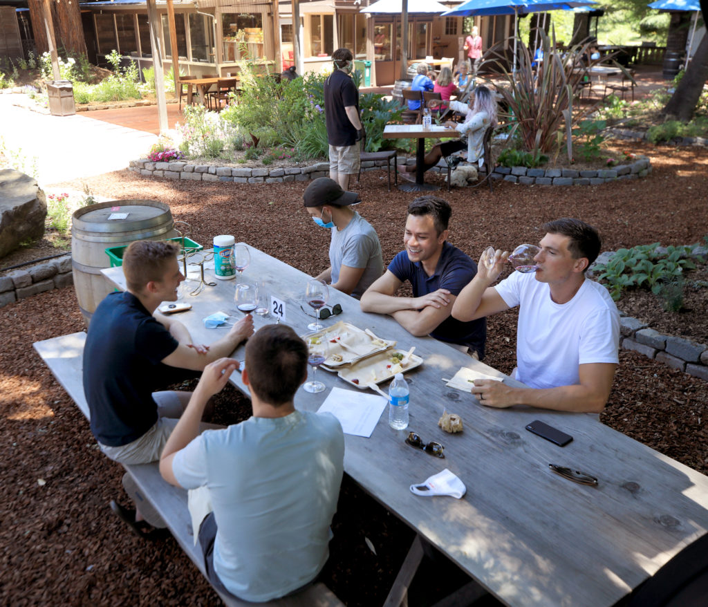 A group of men from San Francisco eat lunch and taste wine at Russian River Vineyards, Saturday, May 23, 2020 in Forestville. Saturday was the first day of operation since the shelter in place regulations were handed down. (Kent Porter / The Press Democrat) 2020