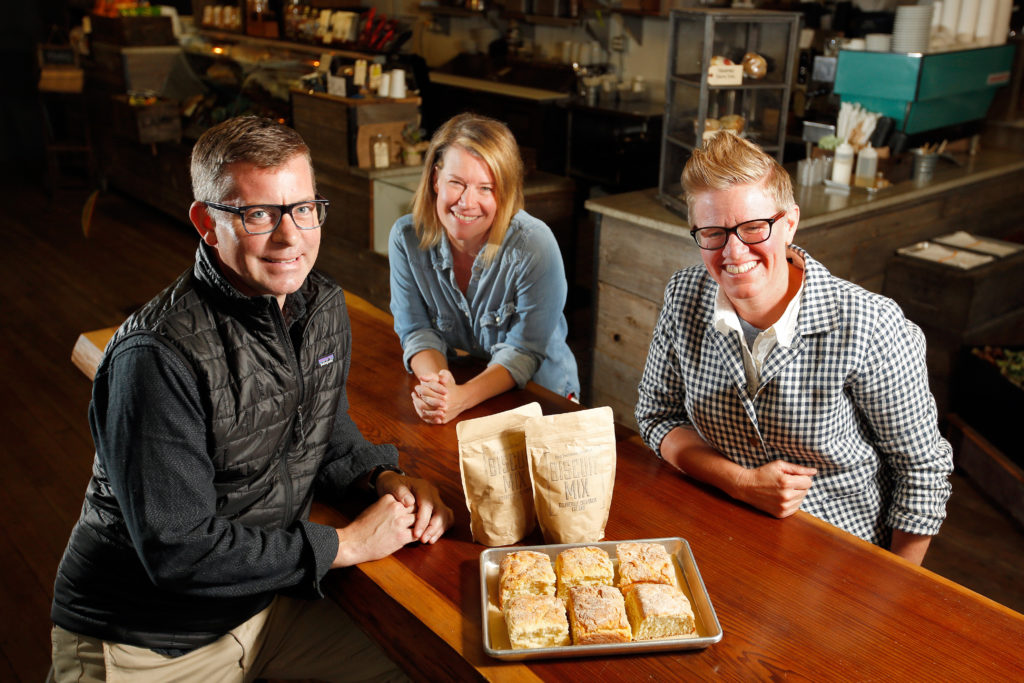 Big Bottom Market partner Michael Volpatt, left, operations director Donna Prowse, and partner Crista Luedtke with their artisanal biscuit mix at Big Bottom Market in Guerneville, California on Wednesday, October 26, 2016. (Alvin Jornada / The Press Democrat)