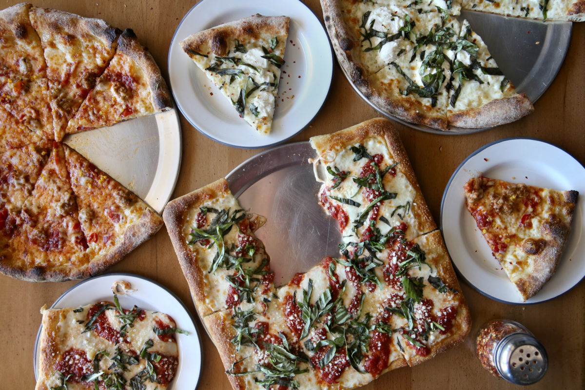 A variety of pizzas, including the Old Grey Beard, left, featuring Italian sausage, Calabrian peppers, hot honey and orange zest, the Spayde, center, a square pan pizza with red sauce, mozzarella, pecorino, olive oil and fresh basil, and the Chingona, top, featuring olive oil, garlic, mozzarella, ricotta and fresh basil at PizzaLeah in Windsor, Calif., on Wednesday, May 27, 2020. (Beth Schlanker / The Press Democrat)