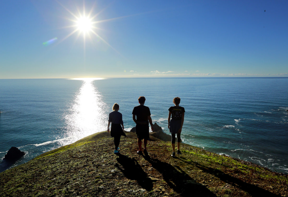 Friends enjoy a hike on the bluffs above Goat Rock beach in Jenner on Thursday. (John Burgess / The Press Democrat)