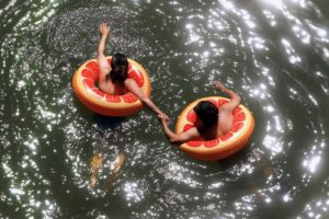 Oakland residents Jude Bermeo, left, and Christine Olivo float down the Russian River, Tuesday, June 4, 2019 in Monte Rio. (Kent Porter / The Press Democrat) 2019
