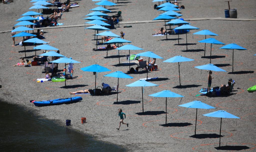 Johnson's Beach on the Russian River in Guerneville reopened, Friday, June 19, 2020, adhering to the County safety measures for safe distancing in response to the coronavirus pandemic . Each spot, marked by orange circles, are 10 feet in diameter with room for four people, the spots are eight feet apart from one another. Reservations are required, parking is $7. (Kent Porter / The Press Democrat) 2020