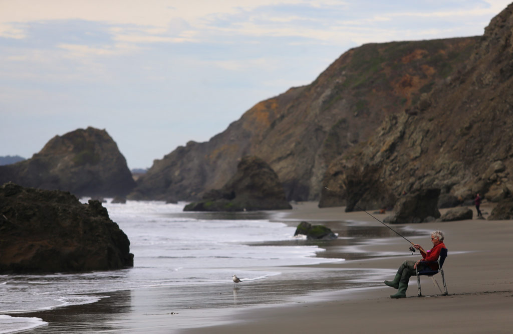 Mike Clark, of Santa Rosa, fishes on a beach near the Pinnacle Gulch Coastal Access Trail, south of Bodega Bay on Tuesday, January 2, 2018. (Christopher Chung/ The Press Democrat)