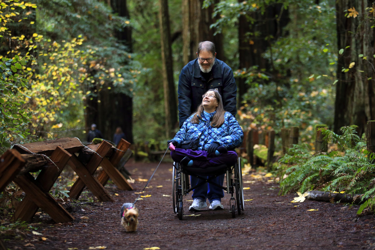 Kathy Stice and Dan Rawsthorn, of Seattle, take a trail designed for the disabled at Armstrong Woods State Park in Guerneville on Wednesday. State Parks will offer free admittance to some parks on Green Friday, the day after Thanksgiving. (John Burgess/The Press Democrat)