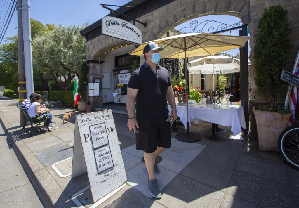 Rob Della Santina, proprietor of Della Santina’s Trattoria, Rosticceria on East Napa Street, on the pavement in front of his restaurant. (Robbi Pengelly/Index-Tribune)