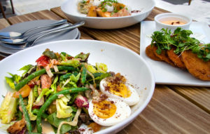Smoked trout salad with green beans and hard boiled eggs, tomato and stone fruit salad, fried green tomatoes at Blue Ridge Kitchen in Sebastopol. (Heather Irwin / The Press Democrat)