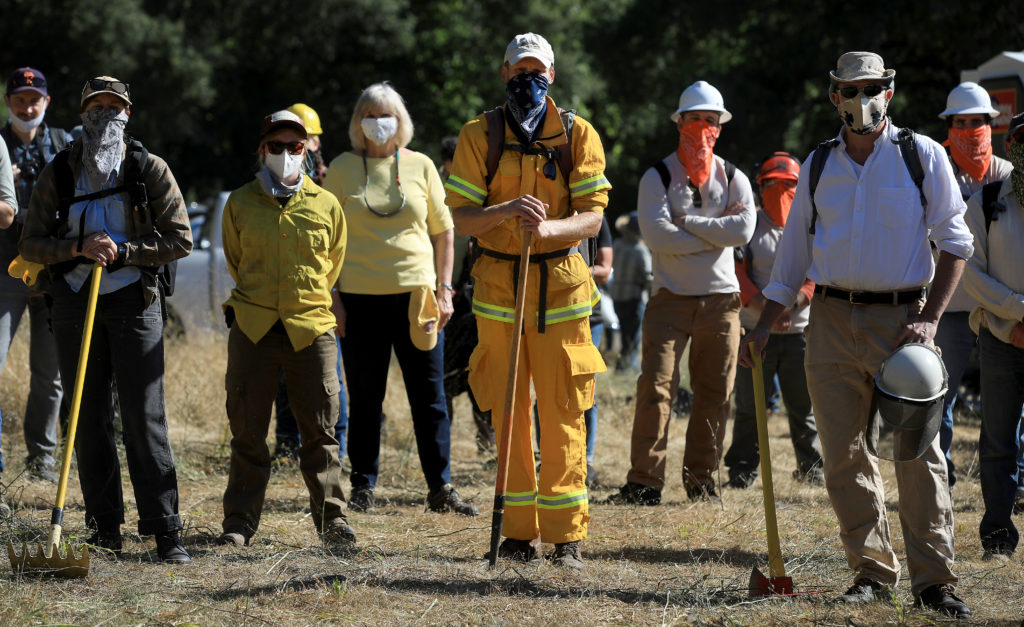 Volunteers receive safety instructions prior to a prescribed burn at the Van Hoosear Wildflower Preserve in Sonoma, May 22, 2020. (Kent Porter / The Press Democrat) 