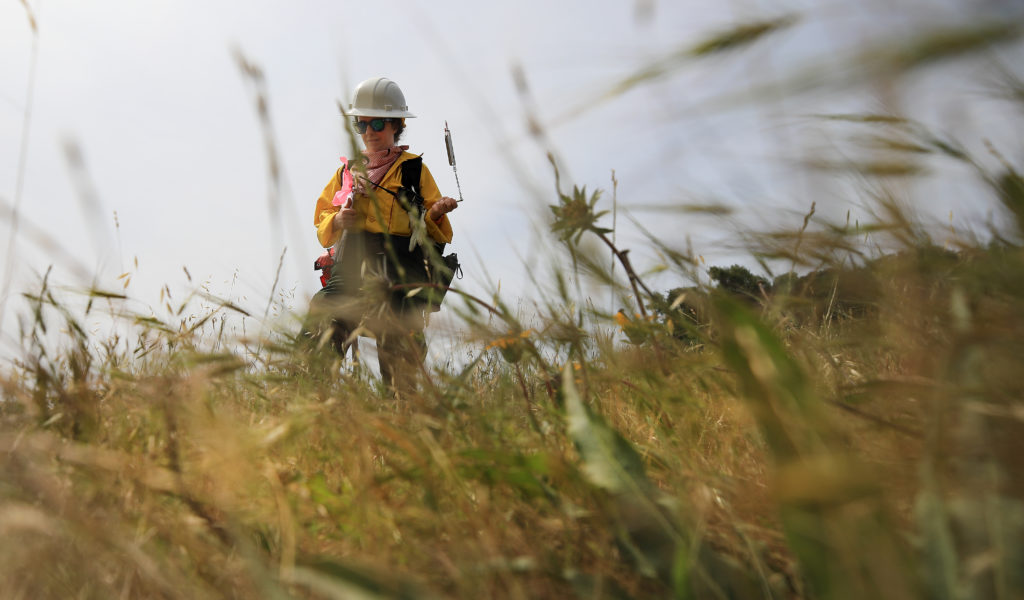 Monica Delmartini with Ag and Open Space District uses a sling psychrometer to manually measure the wet and dry bulb, humidity and temperature during a beneficial prescribed burn at the Van Hoosear Wildflower Preserve in Sonoma, May 22, 2020. (Kent Porter / The Press Democrat) 