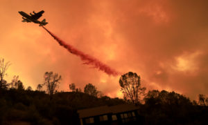 A tanker drop protects homes in Spanish Flat on the Hennessey fire, Tuesday, August 18, 2020. (Kent Porter / The Press Democrat) 2020