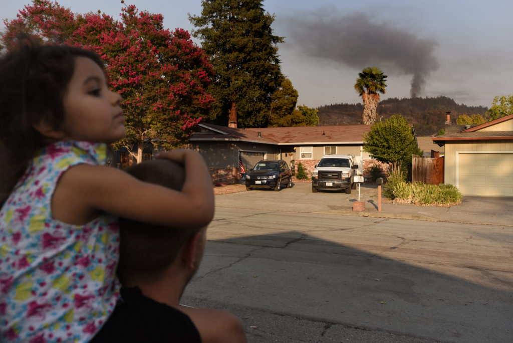 Michale Peterson with his daughter Ellianna Peterson, 4, after arriving back to their home on Baird Road are unnerved by a plume of smoke coming from behind a hillside visible from their driveway after mandatory evacuation orders were lifted in the the Rincon Valley neighborhood of Santa Rosa, Calif. on Tuesday, September 29, 2020. ÒWeÕll leave our bags packed and by the door,Ó said his wife Megan Fernandez who added that the entire family spent one of their nights evacuated sleeping on her office floor in Santa Rosa. (Photo: Erik Castro/for The Press Democrat)
