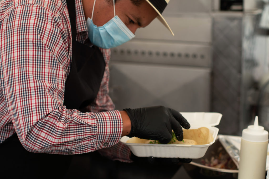 Neil Pacheco of Tamales Oaxaquenos preparing a tamale in Roseland. (Heather Irwin / The Press Democrat)