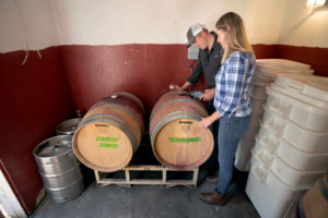 Emily Ernst and husband Greg, home winemakers topping off their zinfandel