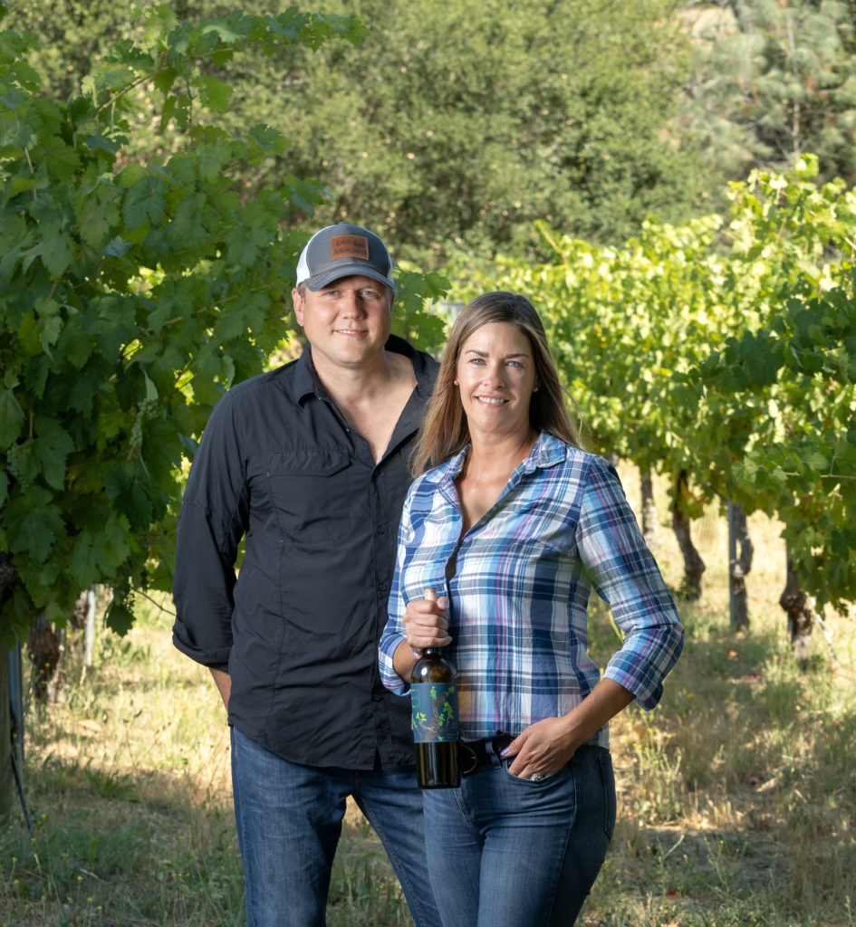 Emily Ernst and husband Greg, home winemakers in their vineyard with one of the zinfandels