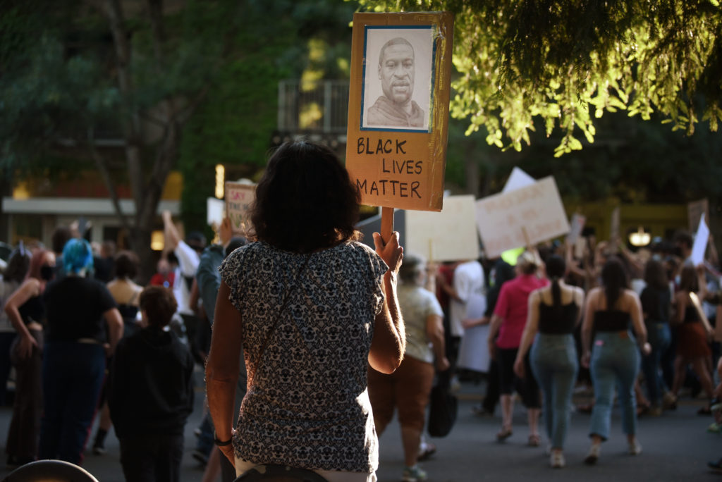 A protester with an image of George Floyd on her sign as she stand on Healdsburg Avenue during a George Floyd protest held Thursday in Healdsburg, Calif., on June 4, 2020. (Photo: Erik Castro/for The Press Democrat)