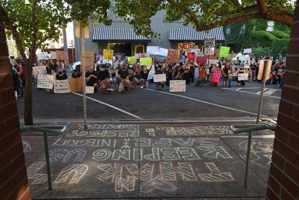 A large group of protesters kneel at the Healdsburg police station during a George Floyd protest held Thursday in Healdsburg, Calif., on June 4, 2020. (Photo: Erik Castro/for The Press Democrat)
