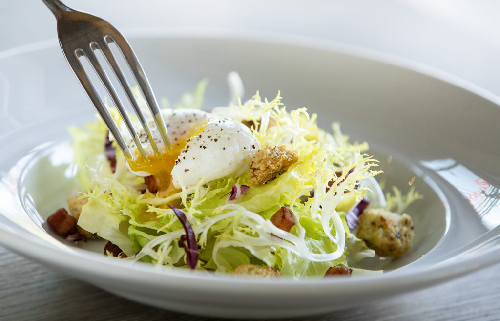 Bistro Salad with bacon, poached egg, croutons, escarole and frisée from Flavor Bistro in Sebastopol. (John Burgess/The Press Democrat)