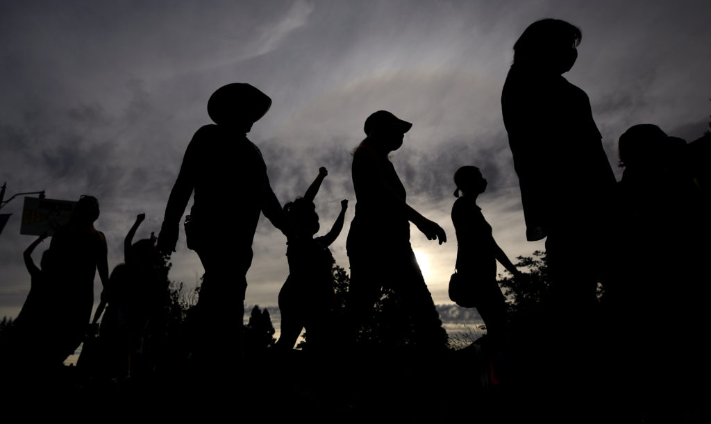Protesters walk around the Healdsburg roundabout in honor of George Floyd, Thursday, June 11, 2020. (Kent Porter / The Press Democrat) 2020