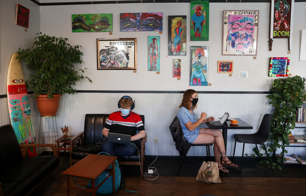 Rebeckah Rubanowitz, right, and Julian Sharp work on their laptops at Retrograde Coffee Roasters in Sebastopol on Friday, October 8, 2021. (Christopher Chung/ The Press Democrat)