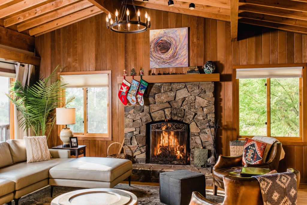 A rustic stone fireplace warms the main living room. (Rebecca Gosselin / Sonoma Magazine)