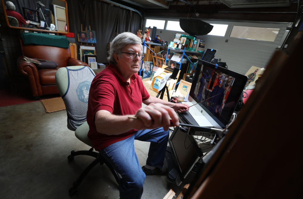 Artist John Deckert works on a painting of a pair of firefighters, using a photograph as reference, at his home in Santa Rosa on Thursday, April 23, 2020. Deckert is making small paintings of essential workers, performing their duties during the shelter in place. (Christopher Chung / The Press Democrat)