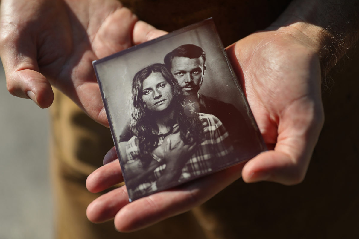 Jeremiah Flynn, owner of Jeremiah's Photo Corner, holds one of his tintype portraits. (Christopher Chung / The Press Democrat)