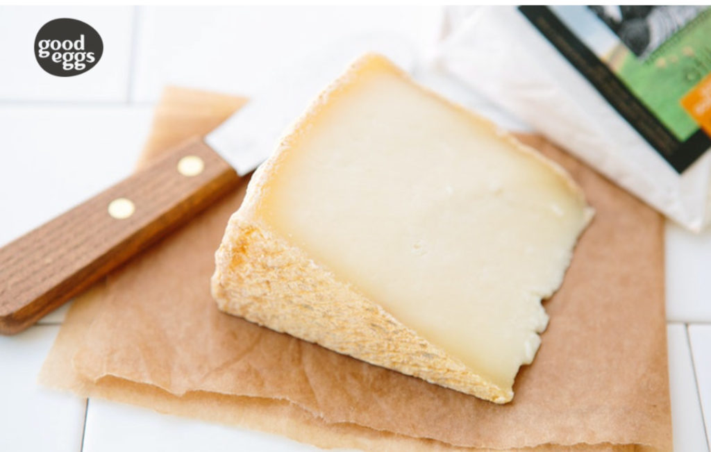Tomales Farmstead Creamery's Atika: A hard, washed rind, aged goat and sheep's milk cheese. "Atika, named for the Miwok word for "two," blends farmstead goat and sheep milk into a firm wheel that boasts a beautiful, natural, brushed rind. The flavor profile is gentle, with flavors of nuts and grass, and a richness from the sheep's milk." Photo courtesy of Good Eggs.