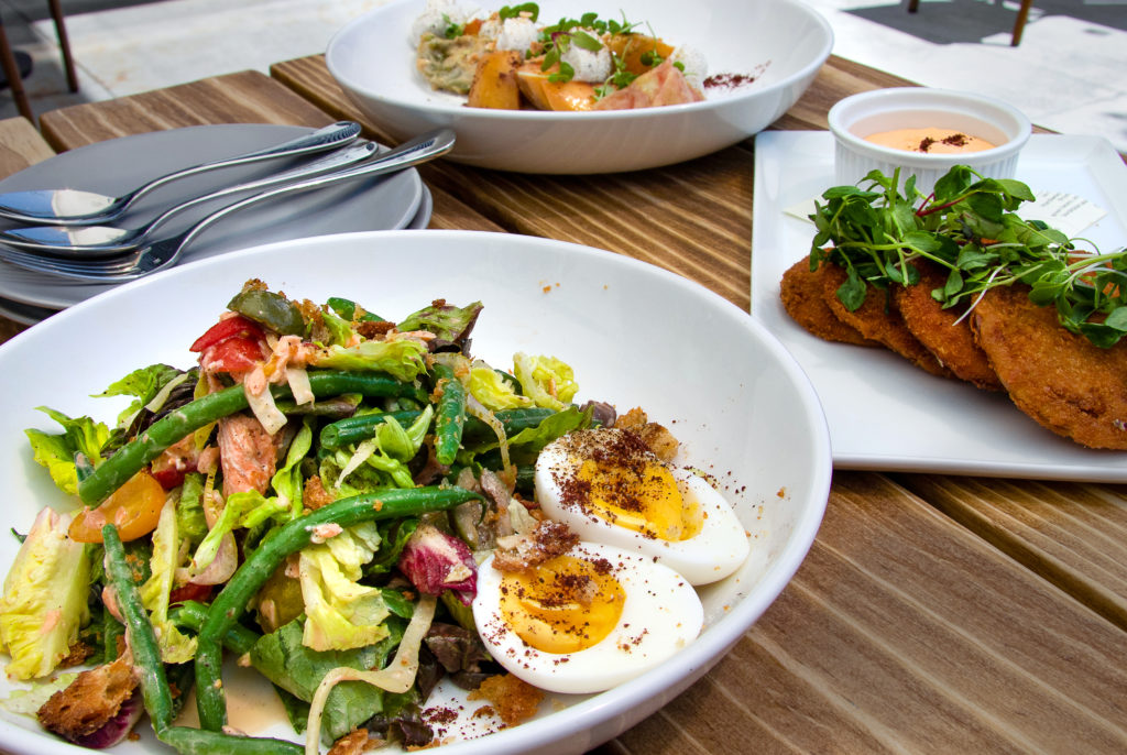 Smoked trout salad with green beans and hard boiled eggs, tomato and stone fruit salad, fried green tomatoes at Blue Ridge Kitchen in Sebastopol. (Heather Irwin / Sonoma Magazine)