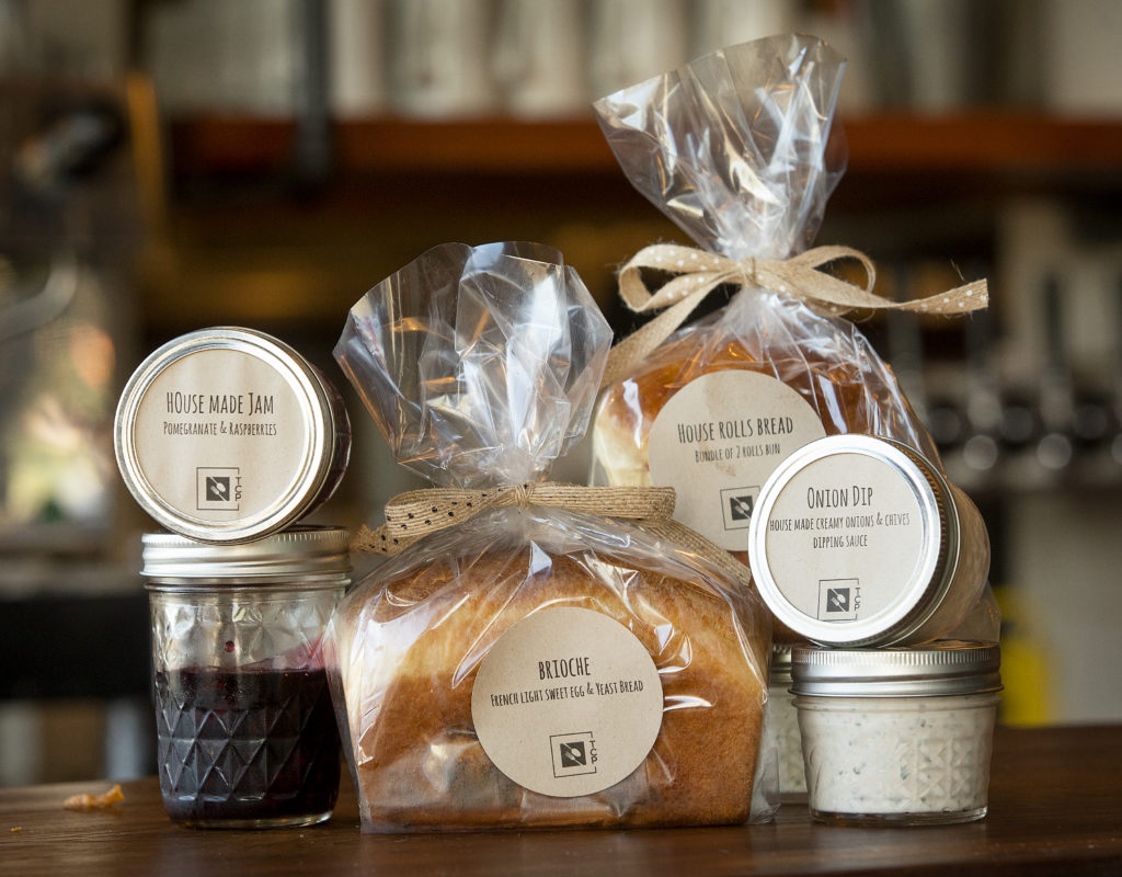 House Made Pomegranate and Raspberry Jam, Brioche, House Bread Rolls and Onion Dip from Table Culture Provisions in Petaluma. (John Burgess/The Press Democrat)