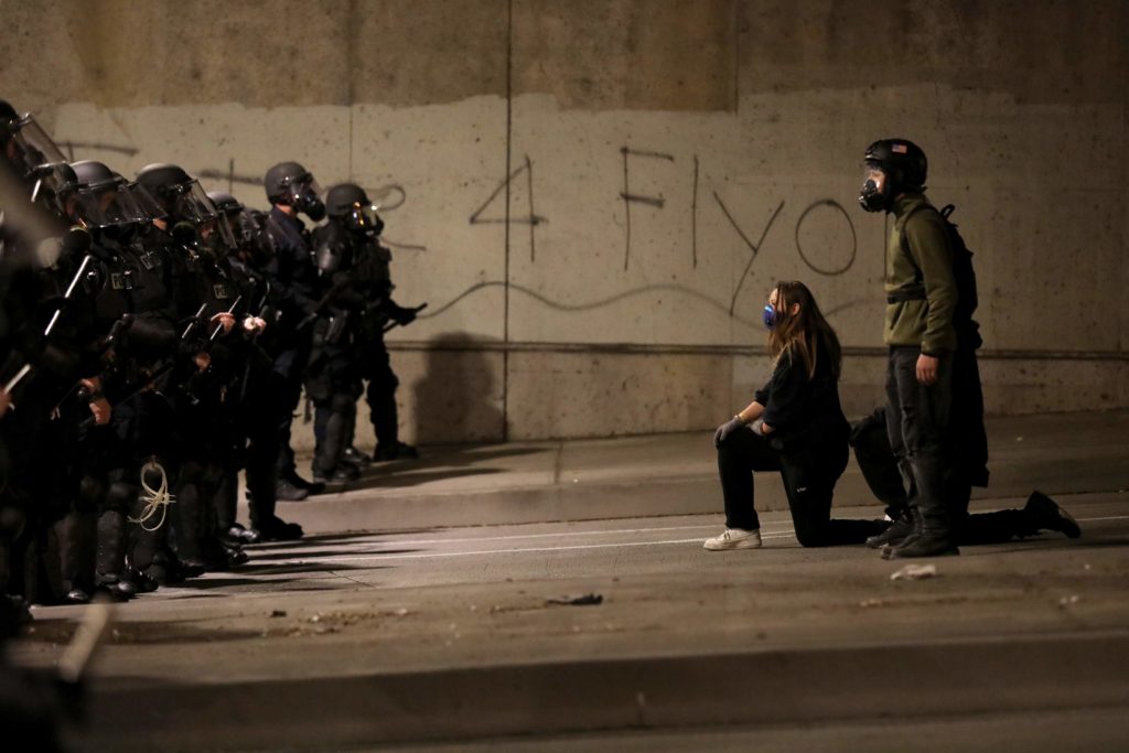 Protesters face off against a line of police officers on Third Street in Santa Rosa, Calif., on Sunday, May 31, 2020. (BETH SCHLANKER/ The Press Democrat)