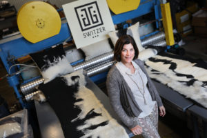 Jessica Switzer Green, founder of JG Switzer, with some of her company's Heritage Sheep Collection, in the Genesis fabric style, and needle loom. JG Swtizer produces luxury blankets and bedding out of a workshop at The Barlow, in Sebastopol. (Christopher Chung / The Press Democrat)