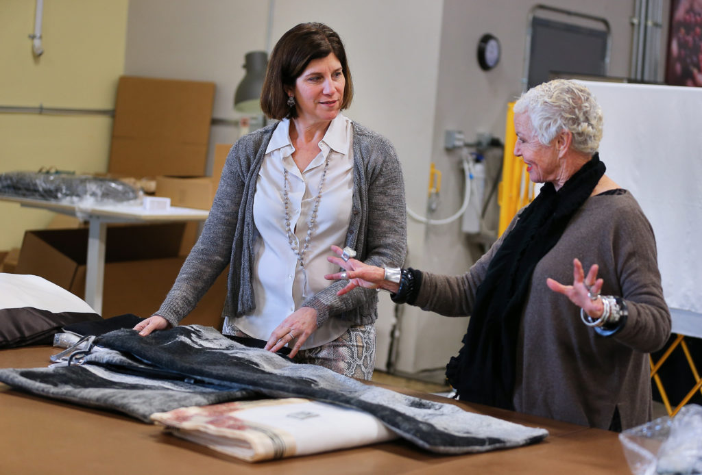 Jessica Switzer Green, left, founder of JG Switzer, talks with Melanie Martin, head of design, in their workshop at The Barlow, in Sebastopol on Monday, February 11, 2019. (Christopher Chung / The Press Democrat)