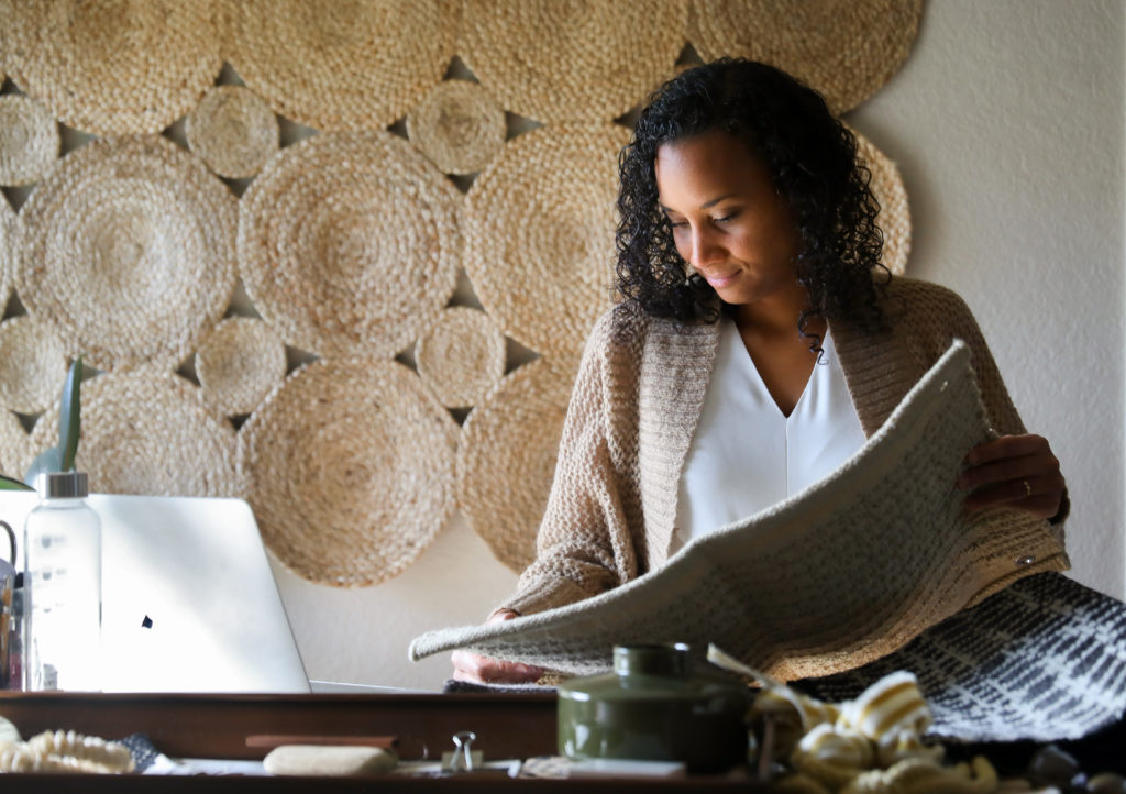 Interior designer Stephanie Meyer looks over rug samples for a client in Santa Rosa on Thursday, November 12, 2020. (Christopher Chung/ The Press Democrat)