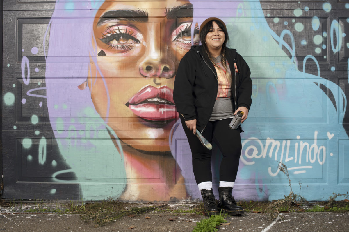 Painter and street mural artist MJ Lindo-Lawyer at a mural she created on a building on Santa Rosa Avenue near Highway 12 in Santa Rosa, January 13, 2021. (Erik Castro/for Sonoma Magazine)