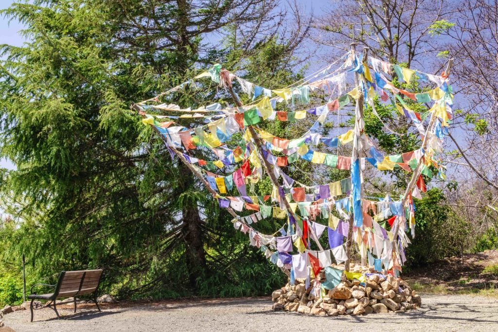 GLEN ELLEN, CA/USA - MAY 19, 2018: Tibetan prayer flags promote peace, happiness, courage, and love at the highest point of Quarryhill Botanical Garden, an Asian woodland garden in Sonoma County.