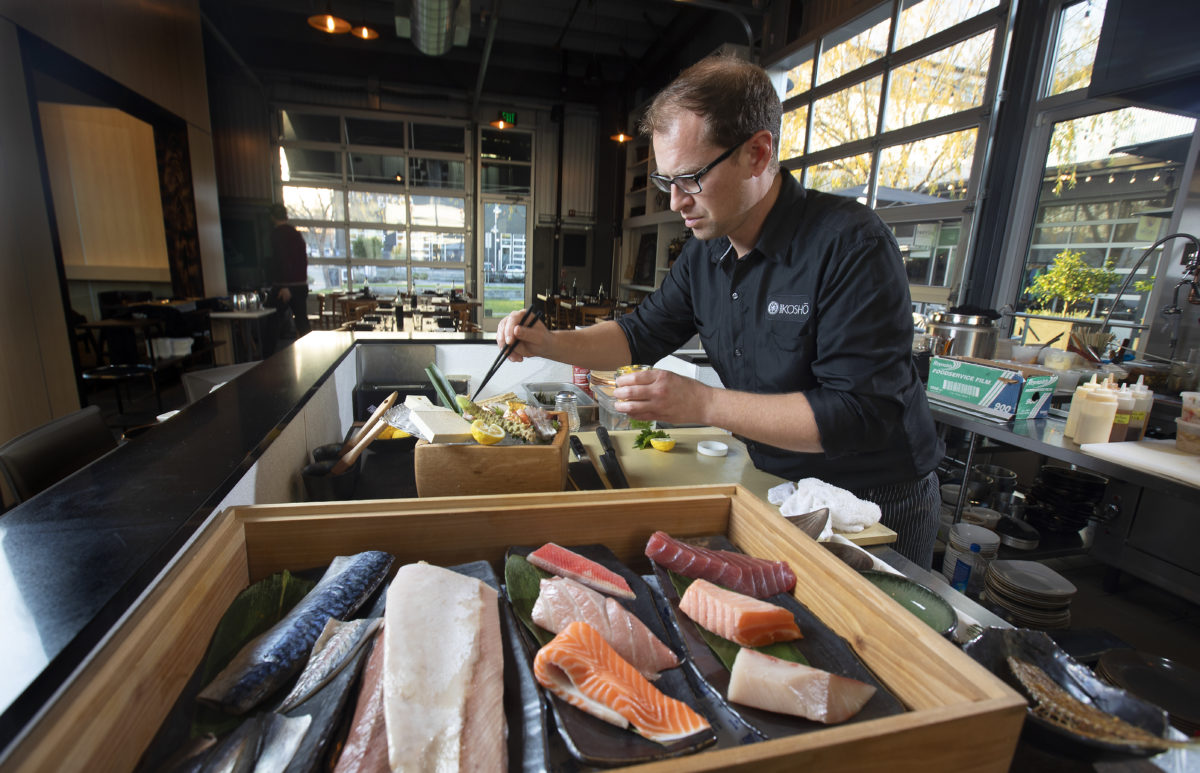 Sushi Kosho chef/owner Jake Rand prepares a Chef's Choice Seasonal Sashimi at the restaurant in Sebastopol's The Barlow. (John Burgess/The Press Democrat)