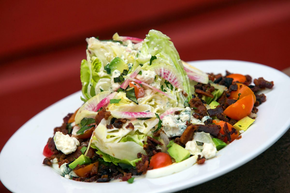 The Roadhouse wedge with iceburg lettuce, cherry tomatoes, avocado, radish, boiled egg, bacon and blue cheese from Fork Roadhouse. (John Burgess / The Press Democrat)