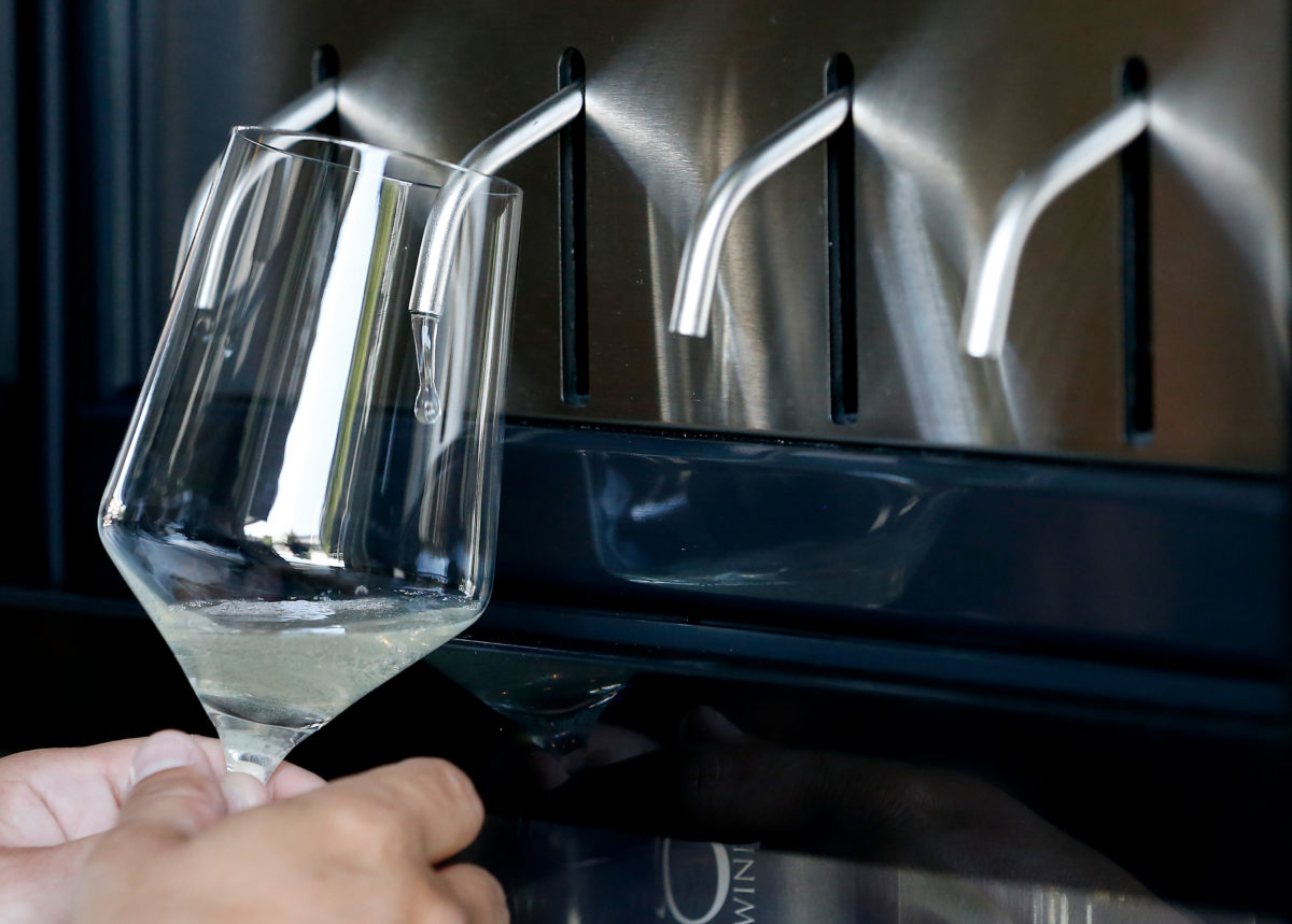 Rich Ciccotelli of Petaluma dispenses a sample of Zo Wines 2018 sauvignon blanc from one of the self-serve wine tasting stations at Region wine bar at the Barlow in Sebastopol. (Alvin A.H. Jornada / The Press Democrat)