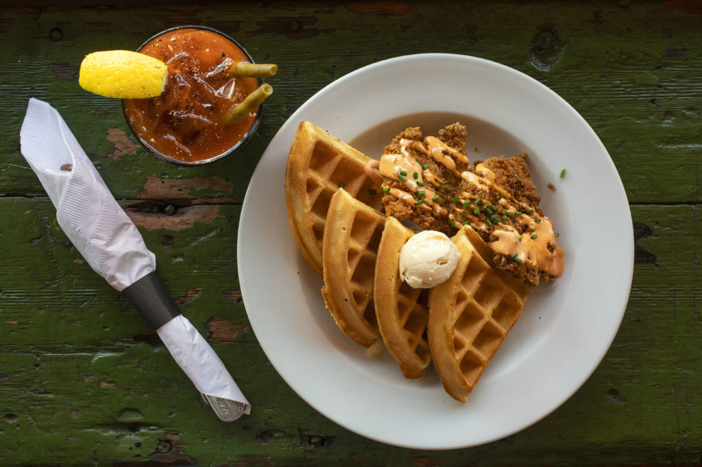 Chicken & Waffles with sriracha cream & organic maple butter and a Bloody Mary from the Gypsy Cafe in Sebastopol on August 13, 2020. (John Burgess/The Press Democrat)