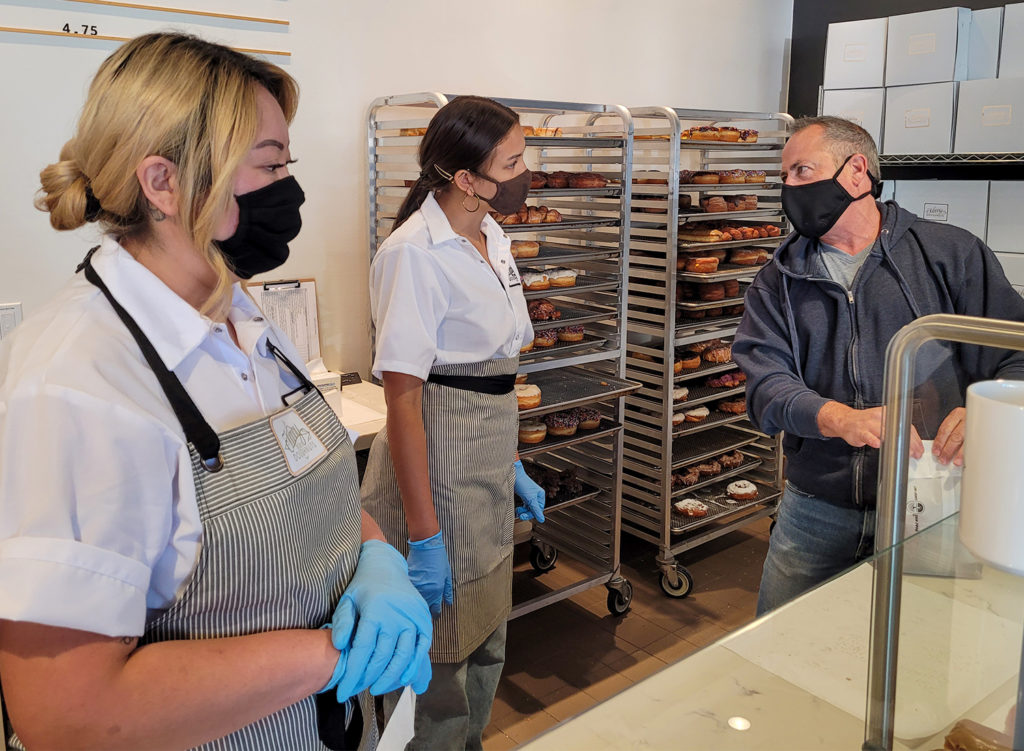 Owner Craig Blum talking to employees at Johnny Doughnuts in Santa Rosa. (Heather Irwin / Sonoma Magazine)