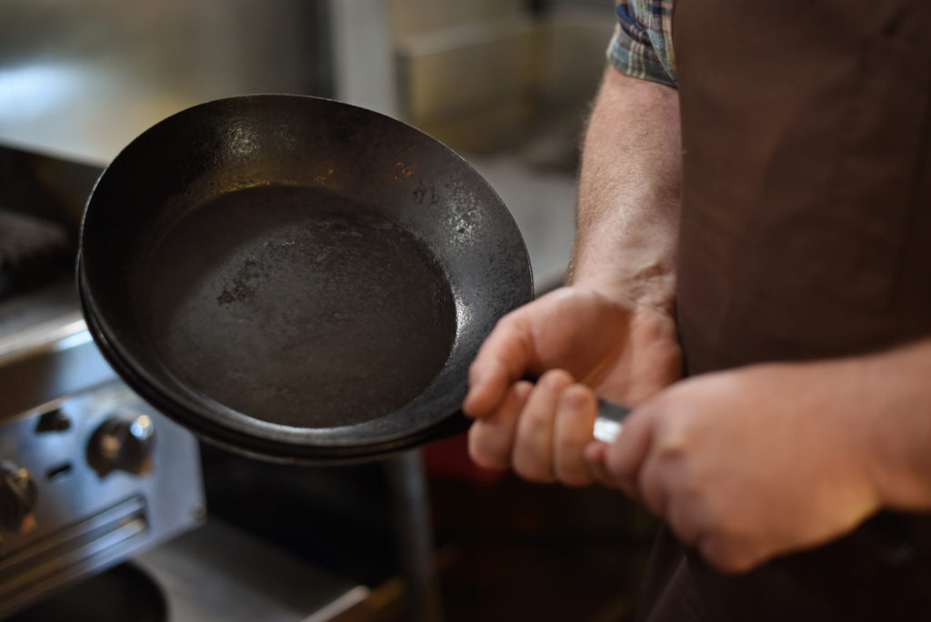 Chef and co-owners Daniel Kedan holding one of first cast iron pans that Kedan and Marianna Gardenhire purchased for Backyard restaurant which they are permanently closing on June 6 after making it through the pandemic in Forestville, Calif. on Tuesday, May 18, 2021. (Photo: Erik Castro/for The Press Democrat)