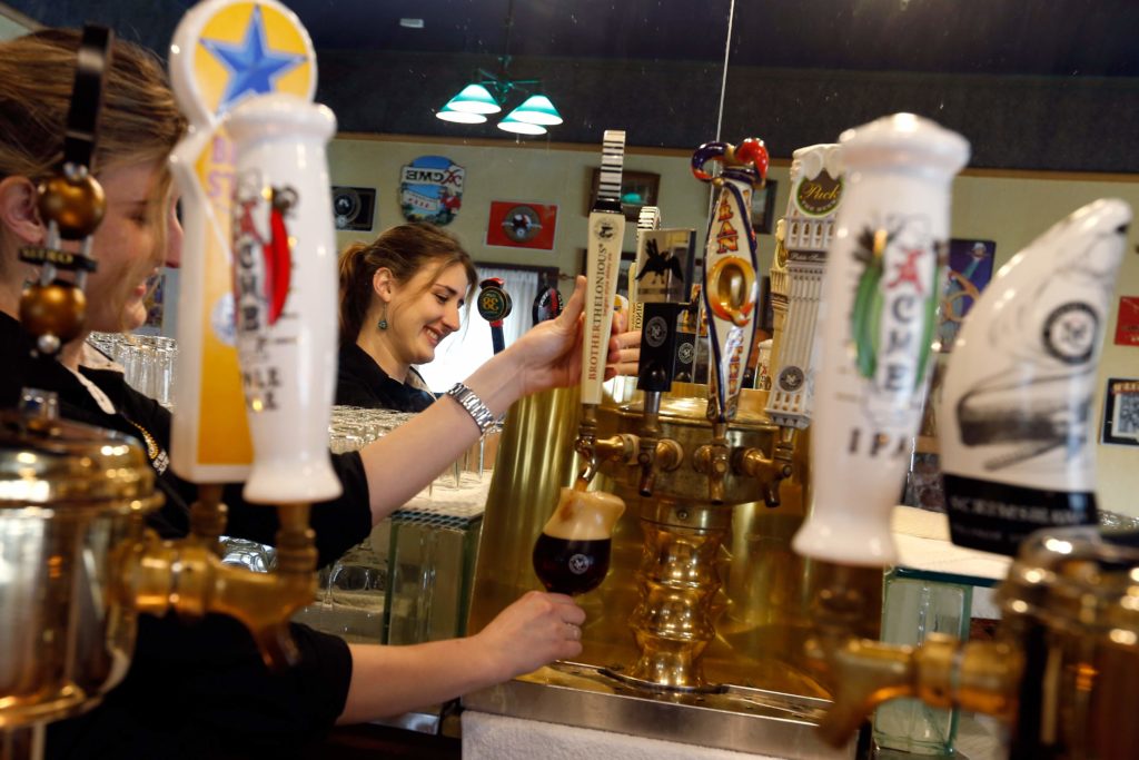 Bartender Jessica Melcher tops off a glass of Brother Thelonious Belgian-style abbey ale in The Taproom at North Coast Brewing Company in Fort Bragg, California, on Thursday, March 10, 2016. (ALVIN JORNADA/ PD)