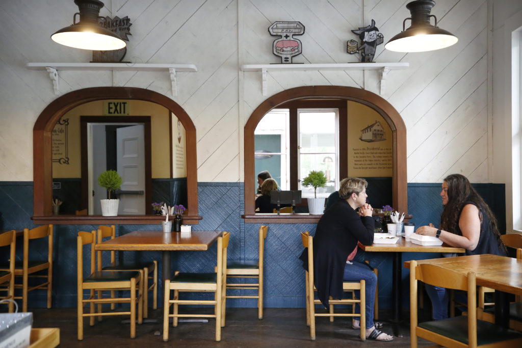 Friends Lori Prior and Diane Madrigal, right, eat breakfast at the Howard Station Cafe in Occidental, Calif., on Thursday, May 13, 2021. (Beth Schlanker/Sonoma Magazine)
