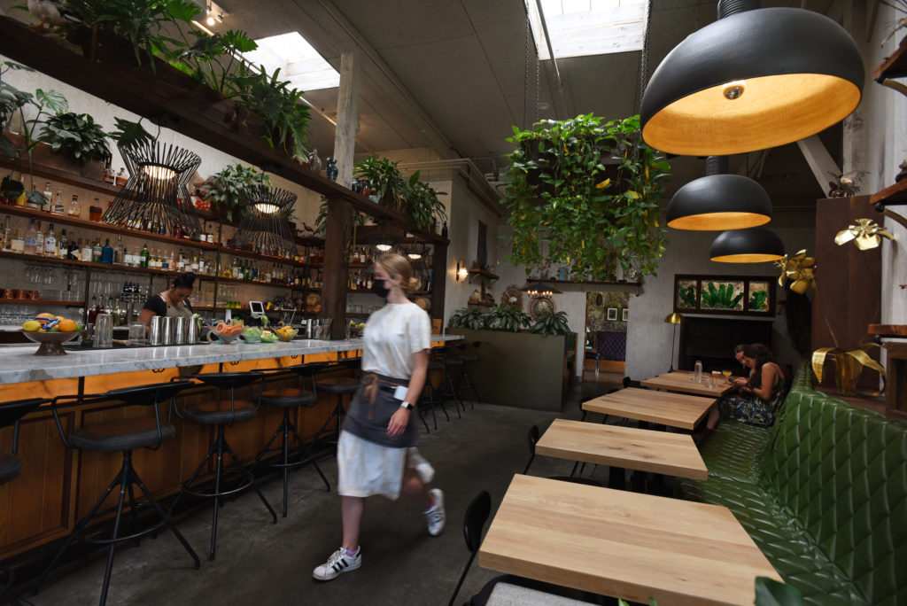 Server Madison Payne walking through the indoor bar area at Fern Bar which is joining a growing list of restaurants now requiring patrons to either show a vaccination card or proof of a negative COVID test within the past 48 hours if they wish to enter their indoor space in Sebastopol, Calif. on Wednesday, July 28, 2021. Customers may also show a photo of their vaccination card or use the state’s QR code system. (Photo: Erik Castro/for The Press Democrat)