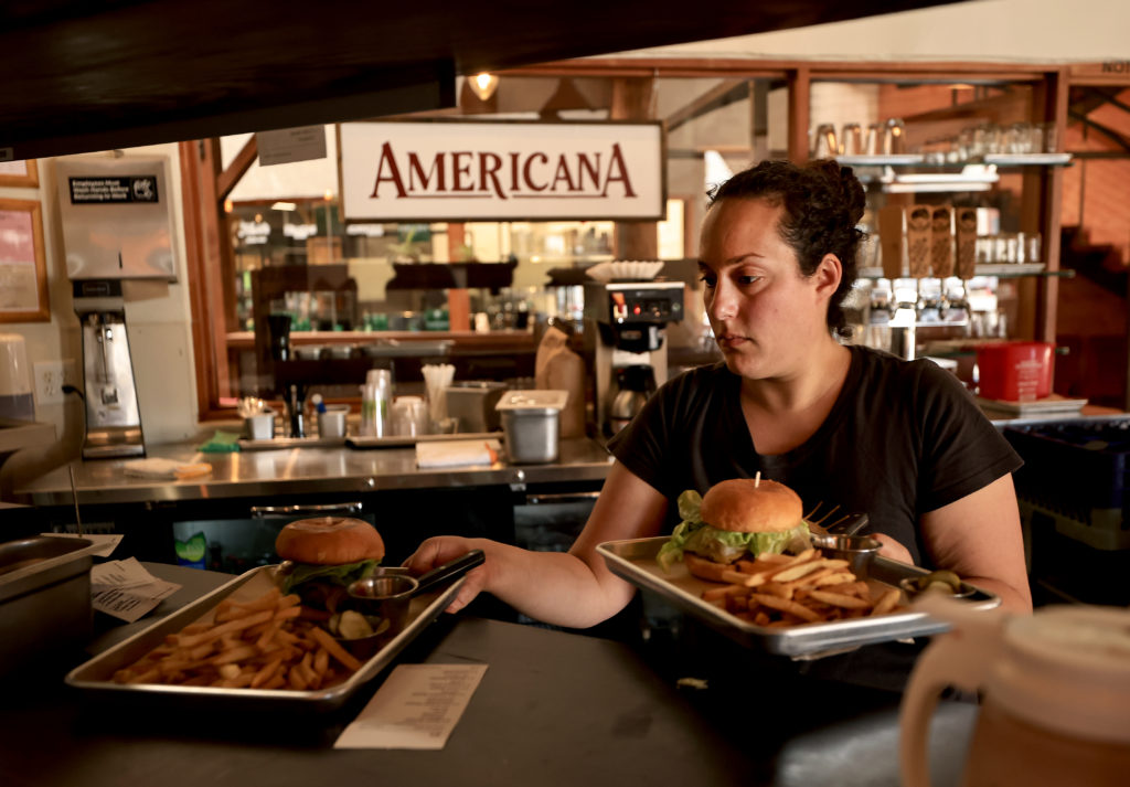 Samantha Ramey, owner of Americana in Santa Rosa, serves up burgers and fries, Saturday, June 19, 2021. (Kent Porter / The Press Democrat) 2021