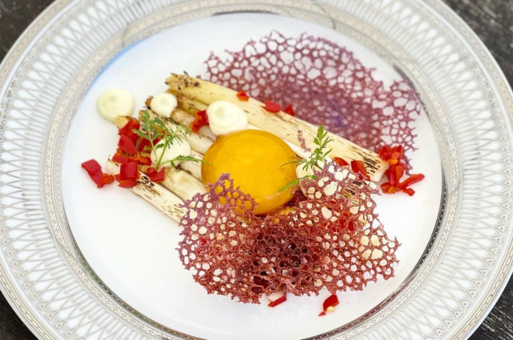 The "Zuke" with roasted and torched asparagus w/ shoyu zuke egg yolk, fermented chilis, cherry relish, mint aioli & ube coral tuiles at Fourth Street Social Club in Santa Rosa. (Courtesy of Fourth Street Social)