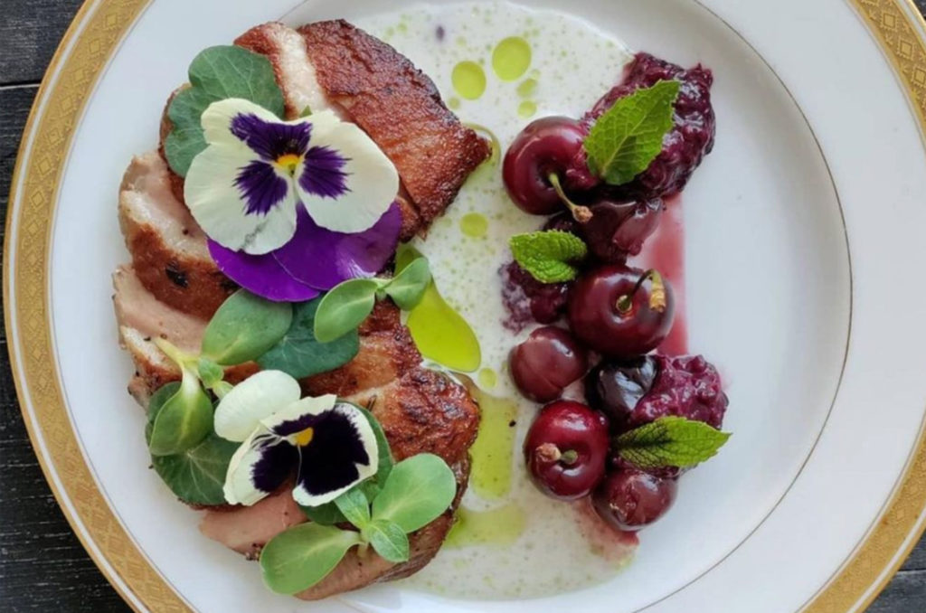 The "Daisy" with seared duck breast, black berry compote, pickled & fresh cherries, watercress, dehydrated raspberry, coconut-lavender milk & herb oil at Fourth Street Social Club in Santa Rosa. (Courtesy of Fourth Street Social)