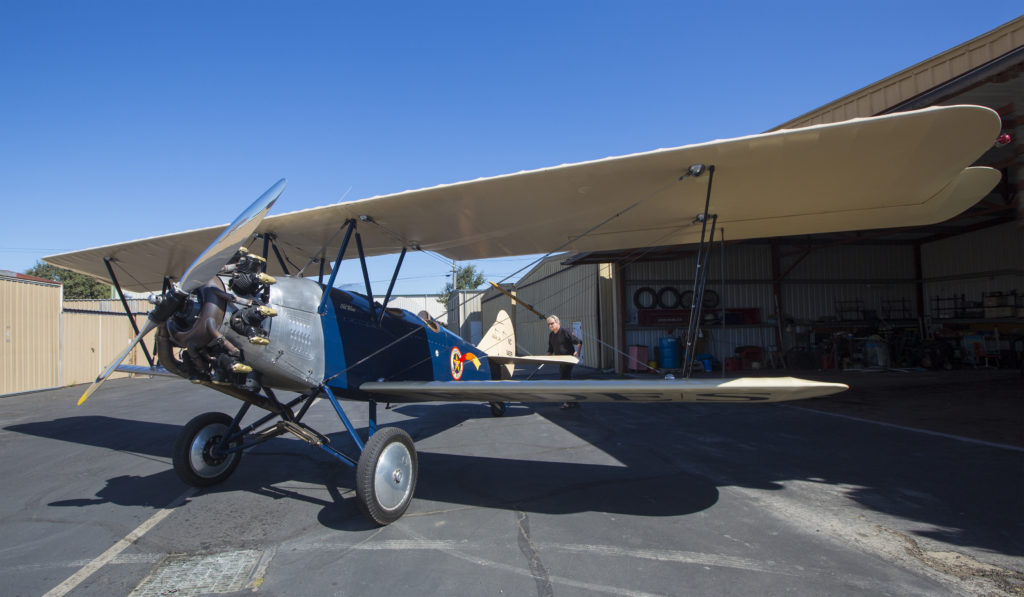 Captain Bob Berwick rolls his 1926 Travelair biplane out of its hangar in advance of a sightseeing flight. (Robbi Pengelly/Index-Tribune)