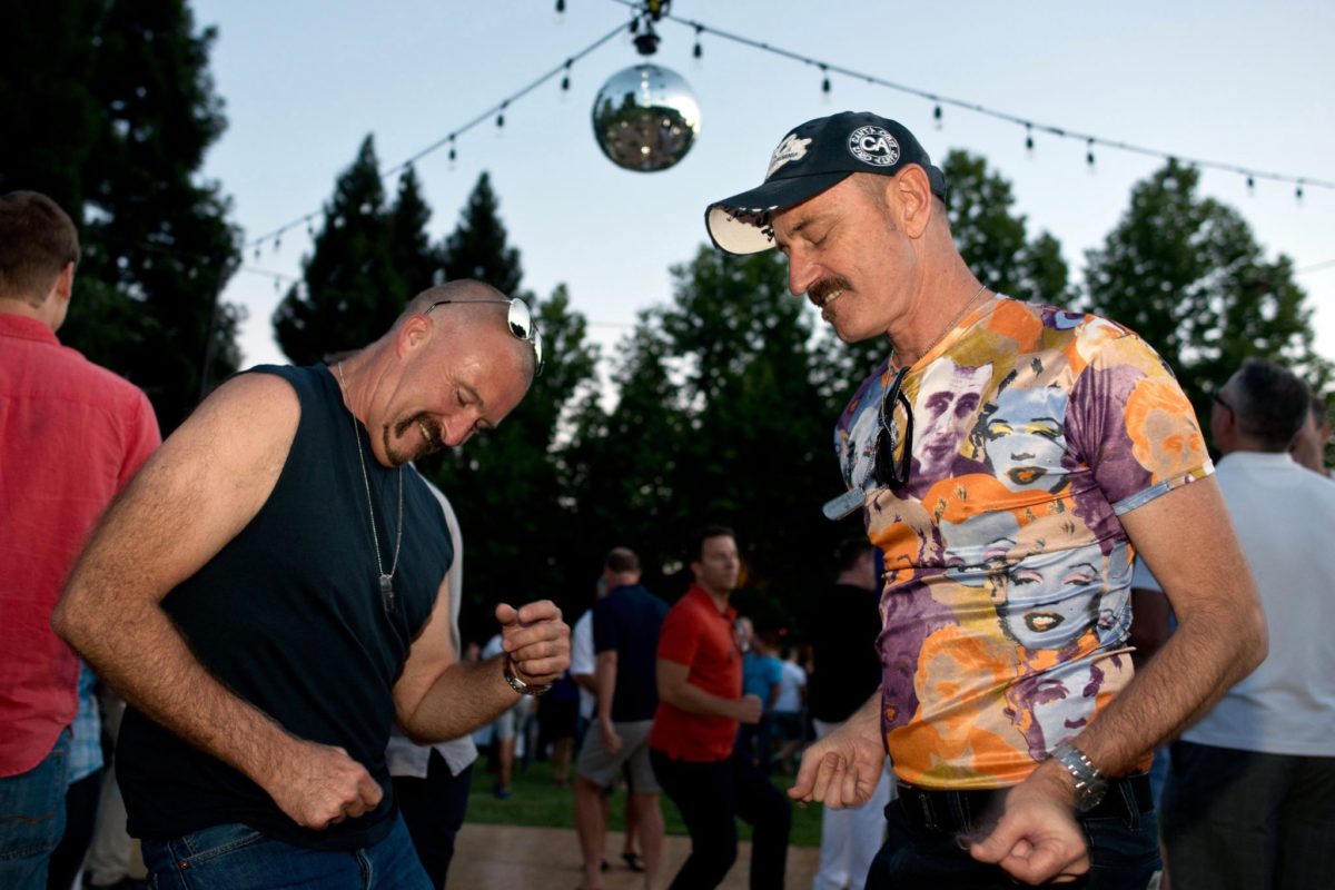 John Ryan, left, and Alex Burns from Australia have fun on the dance floor at Out in the Vineyard's Twilight T-Dance at Raymond Vineyards, benefitting Face to Face Sonoma County AIDS Network, during Gay Wine Weekend in St. Helena, California, on June 14, 2014. (Alvin Jornada / For The Press Democrat)